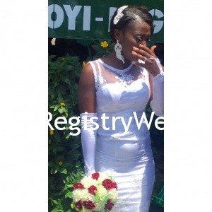 Bride shows off her ring , earring and hair accessory